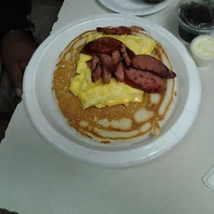 Huge pancake platter: 3 pancakes, eggs and choice of meat.