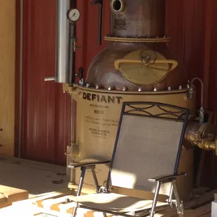 a chair in front of a distilling machine