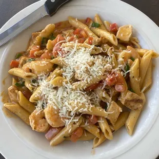 a plate of pasta and a knife