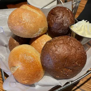 a basket of bread rolls and butter