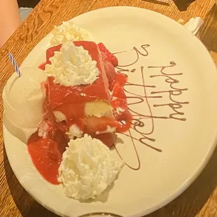 a slice of strawberry cheesecake with whipped cream