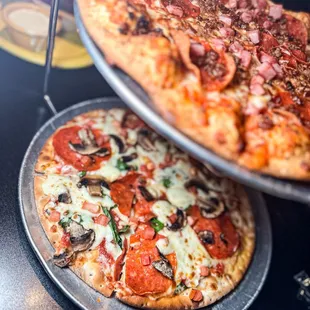 two pizzas on pans