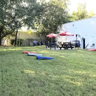 Cornhole and horseshoes available to play in the side yard with outdoor seatings.