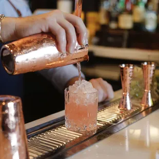 a bartender pouring a drink