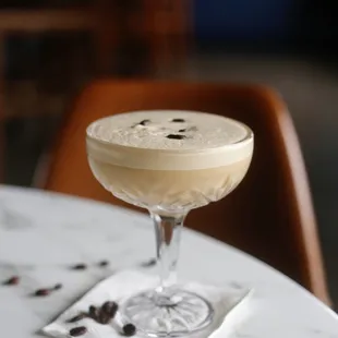 a glass of coffee on a table
