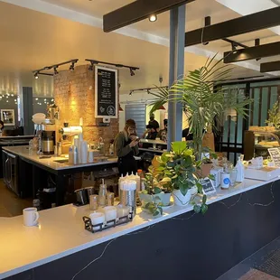 a coffee shop with a counter with a variety of items on it