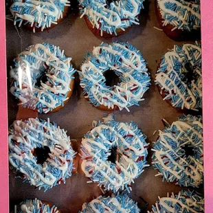 a tray of frosted donuts