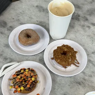 three plates of donuts and a cup of coffee