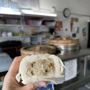 a hand holding a piece of bread