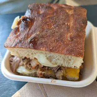 a sandwich in a styrofoam container