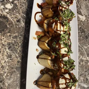 a plate of bananas with sauce and toppings