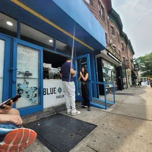two people standing outside a blue star restaurant
