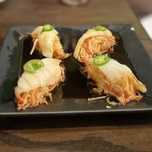 ITCHY SEABASS - baked Seabass on top of spicy crab mix topped with serrano, cilantro and ponzu sauce.