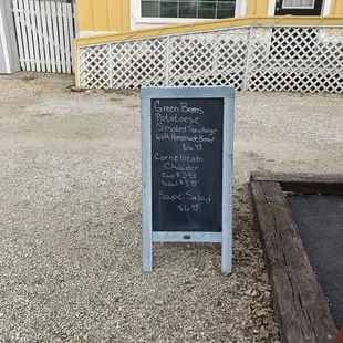a chalkboard sign outside a restaurant