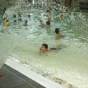 Heated lap swim pool and a zero-entry pool with a river channel