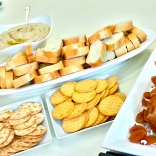 (L to R) Shrimp cocktail, antipasta, baguette, crackers, brie en croute filled with apricot preserves and slivered almonds