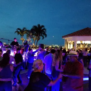 a group of people dancing at night