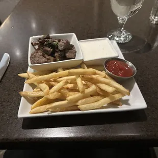 Crispy fries, steak bits and sour cream dip sauce