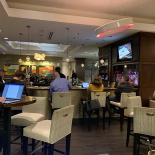 people sitting at tables with laptops