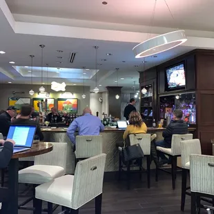 people sitting at tables with laptops