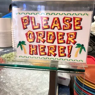 a sign that says please order here