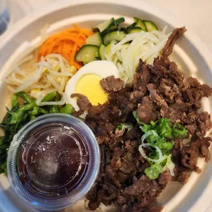 Bibimbap bowl -- is NOT as shown on menu: dry meat and hardboiled egg (not the 6 min gooey egg). Bummer for $18