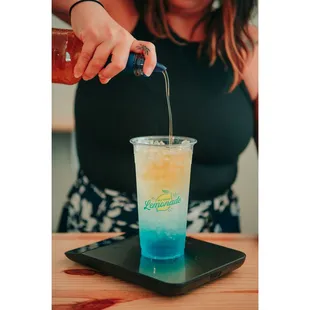 a woman pouring a drink