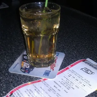 a glass of water with a green straw