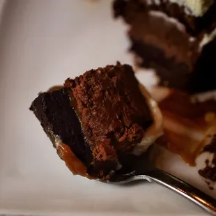 a piece of chocolate cake with ice cream on top