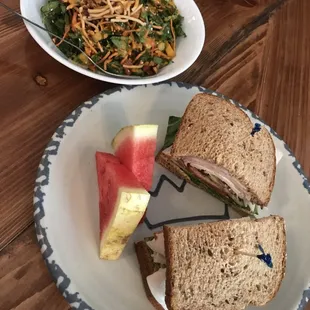 a plate of sandwiches and a bowl of salad