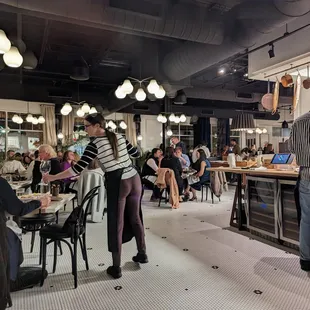 Inside. Dining room. View facing towards storefront windows. Open kitchen to right.