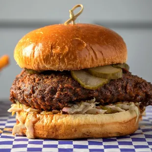 a burger with pickles and pickles on a bun