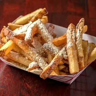 a basket of french fries on a wooden table