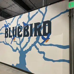 a mural of a tree with blue branches