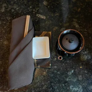 a teapot and a napkin on a table