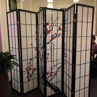 a room divider with a cherry blossom design