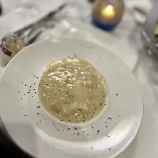 a bowl of soup on a white plate
