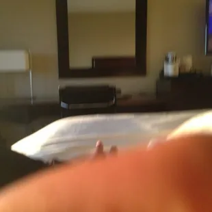 a person's feet on a bed with a television in the background