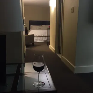 a glass of wine on a coffee table