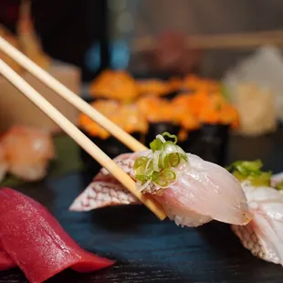 a close up of sushi with chopsticks