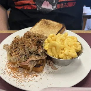 Pulled pork sandwich with macaroni and cheese.