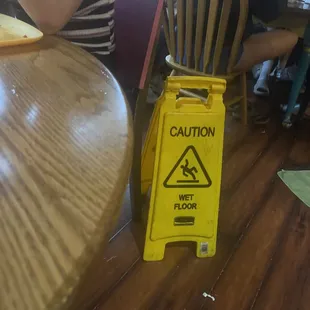 The caution sign they had to put down after halfway cleaning up our table. And this was forever after it happened.