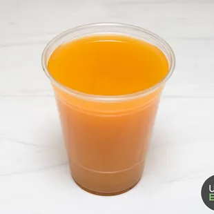 orange juice in a plastic cup