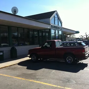 a red truck parked in front of a restaurant
