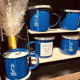 a display of blue coffee mugs