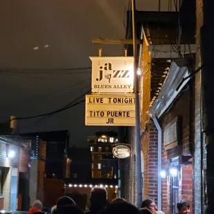 a crowd of people walking down the street