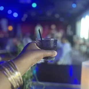 a hand holding a cocktail glass