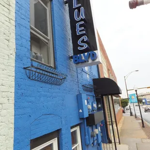 a blue building with a sign that says blues