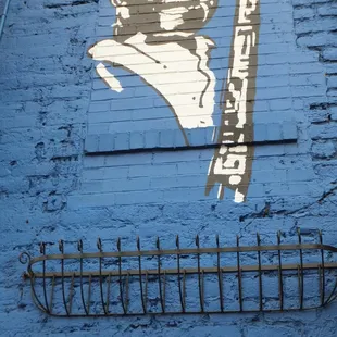 a man holding a flag on the side of a building