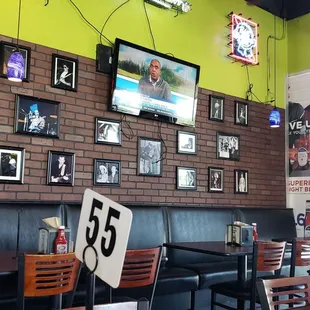 a brick wall with a lot of pictures on it